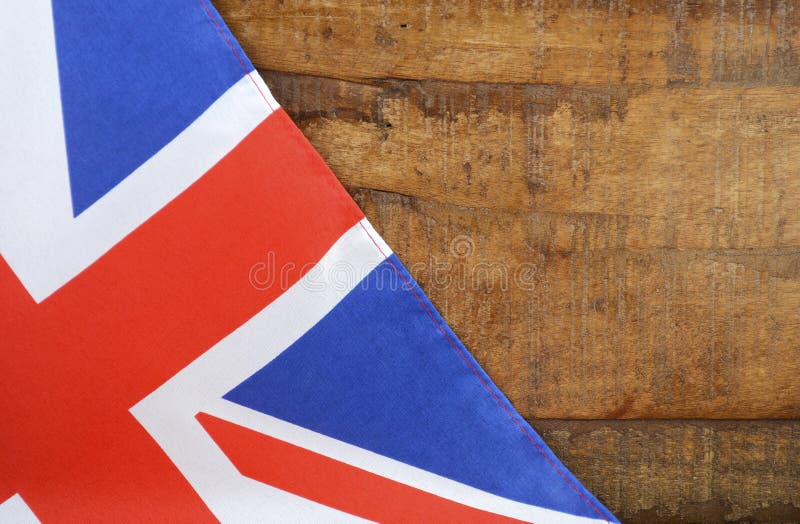 Great Britain UK Union Jack Flag against dark distressed recycled wood background. Great Britain UK Union Jack Flag against dark distressed recycled wood background.