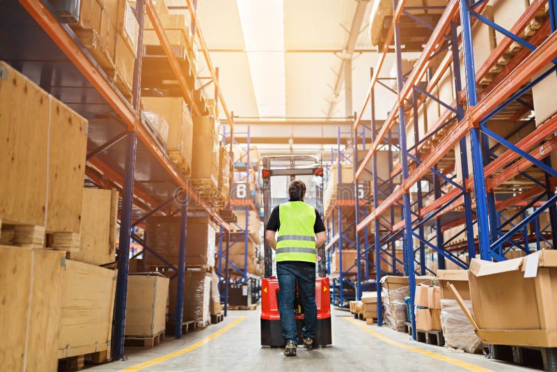 Storehouse Employee in Uniform Working on Forklift in Modern Automatic