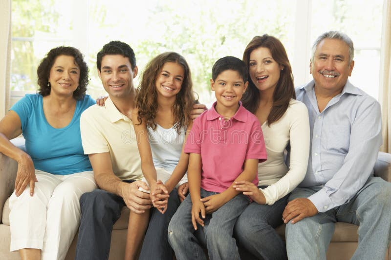 Extended Hispanic Family Relaxing At Home Together. Extended Hispanic Family Relaxing At Home Together