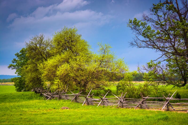 Storm clouds over trees and fence in Gettysburg, Pennsylvania. royalty free stock photography