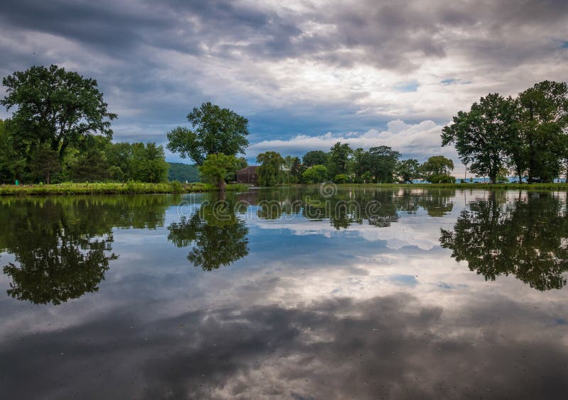 Storm clouds reflect in a pond at Stewart Park in Ithaca, NY