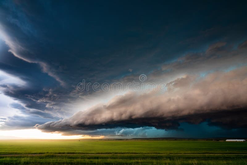 Storm clouds and severe thunderstorm with dramatic sunlight. Stormy sky extreme weather background.