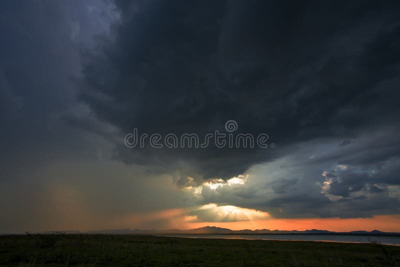 A storm is coming rain cloud are over the mountain and lake on the twilight time. stock photo A storm is coming rain cloud are over the mountain and lake on the twilight time. stock photo
