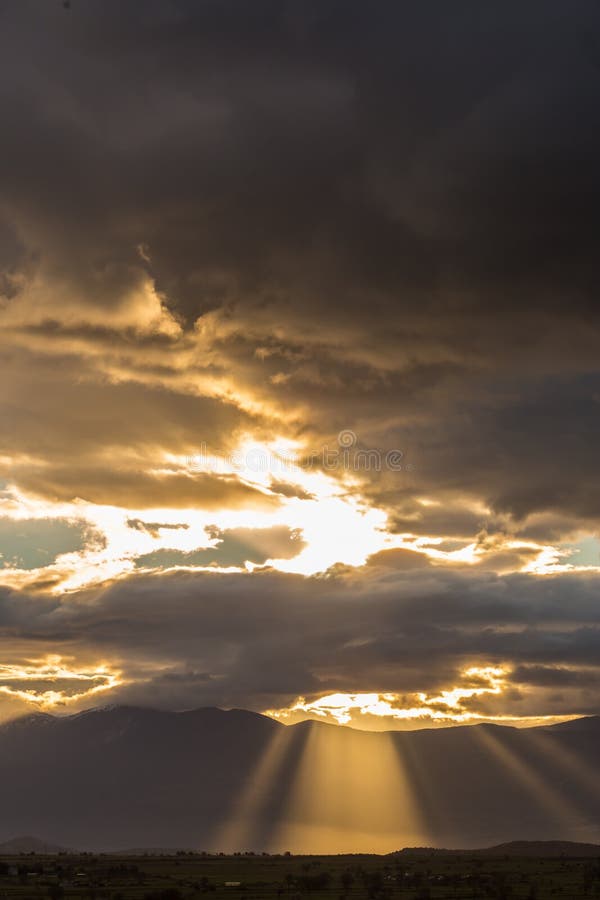Stormy heavy clouds above fields and mountains royalty free stock images