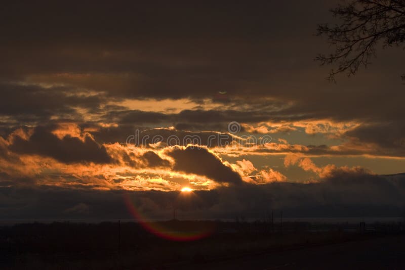 Stormy sunset over Utah Lake with lens flare