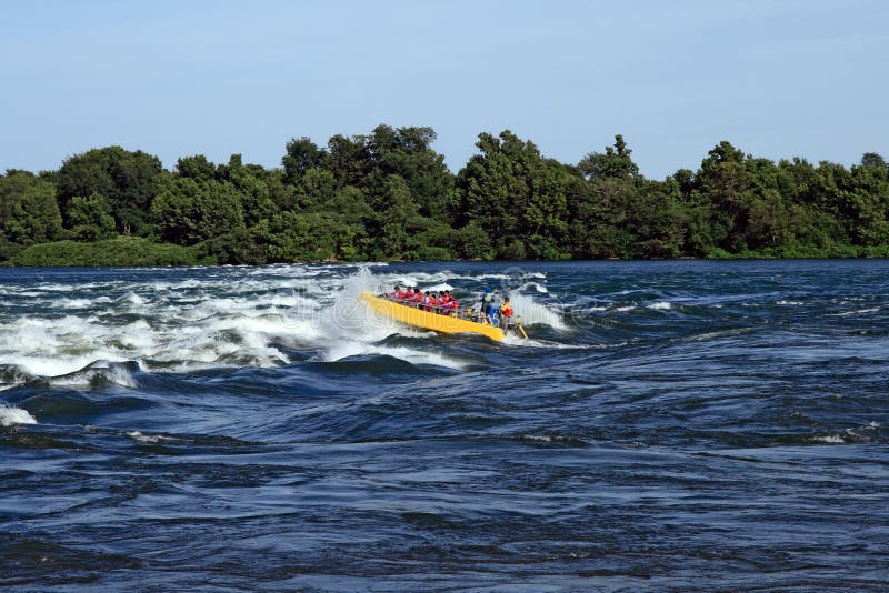 Jet boat coming into a big wave on the river. Jet boat coming into a big wave on the river.