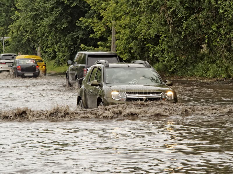 Cars on the street flooded with rain. Cars on the street flooded with rain