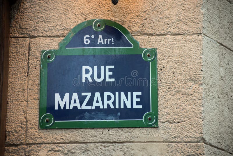 Closeup of Mazarine street on a parisian retro plate on stoned building in the street. Closeup of Mazarine street on a parisian retro plate on stoned building in the street