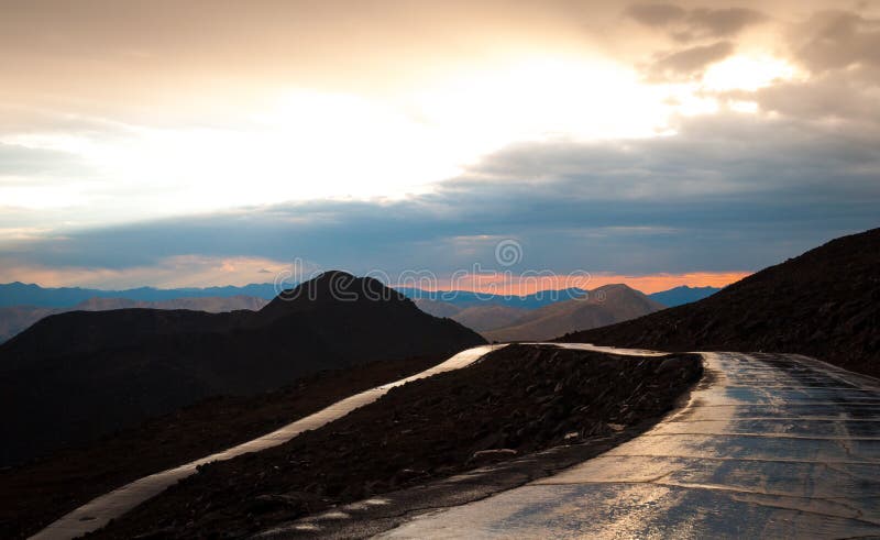 This picture shows the sunset view of the mount Evans road after a rain storm. This picture shows the sunset view of the mount Evans road after a rain storm.