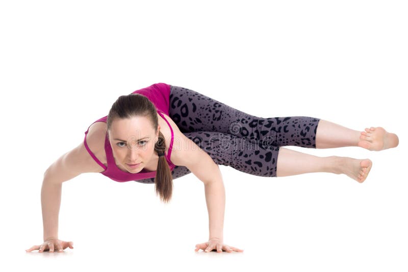 Woman practicing crow pose on footpath Stock Photo - Alamy