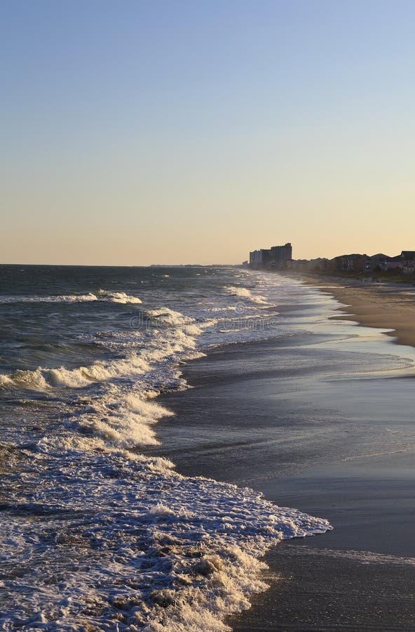 Sunset at Surfside Beach with ocean waves coming to shore. Sunset at Surfside Beach with ocean waves coming to shore