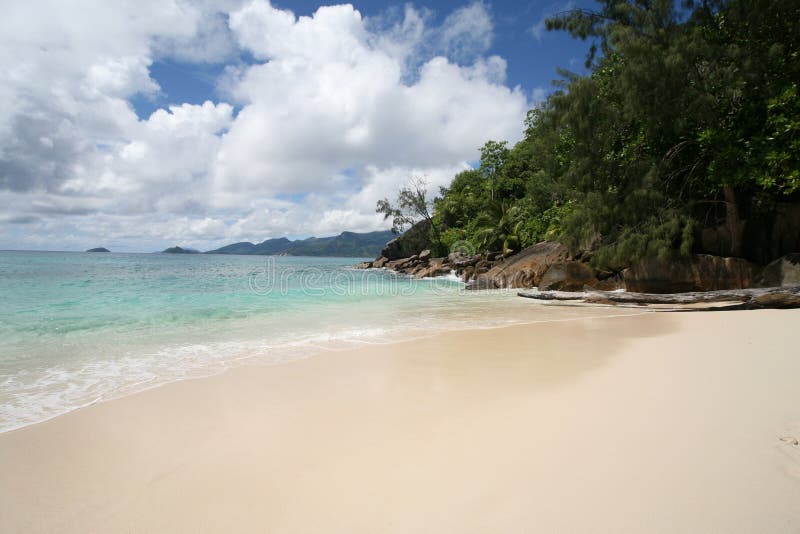 A beach in Mahè with a luxuriant vegetation and turquoise sea (Seychelles). A beach in Mahè with a luxuriant vegetation and turquoise sea (Seychelles)