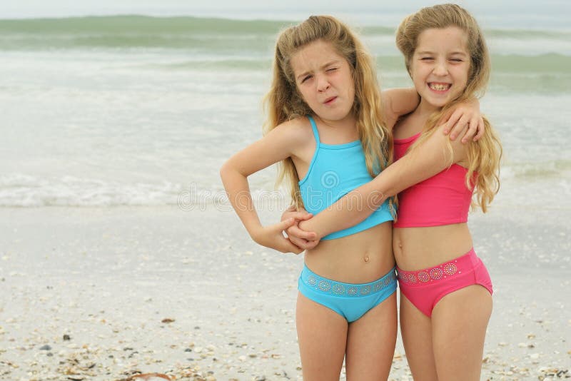 Shot of sisters hugging at the beach. Shot of sisters hugging at the beach