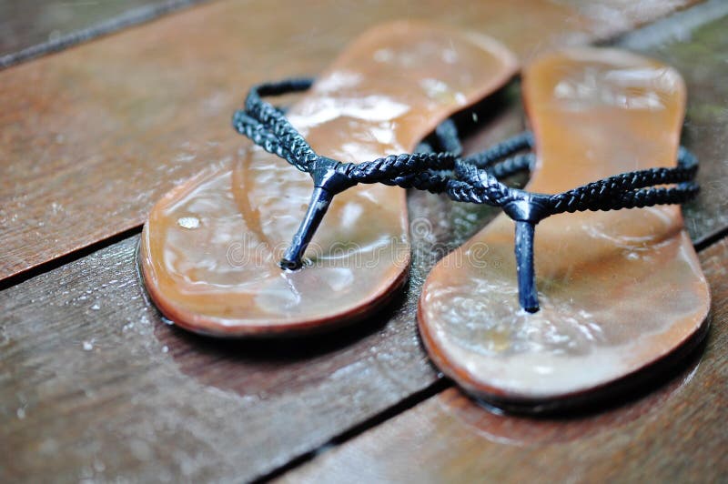 Flip flops on wet wood planks. Flip flops on wet wood planks