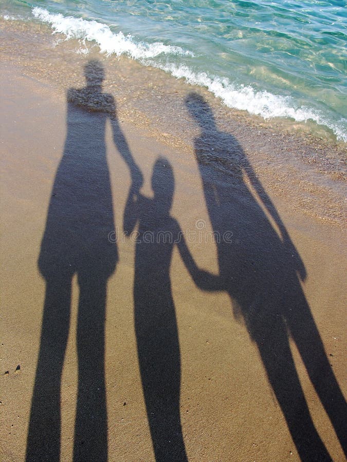 Three shadows on sand beach. Three shadows on sand beach