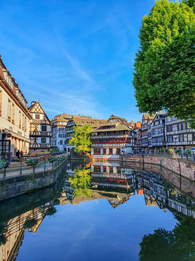 STRASBOURG, FRANÇA - em junho de 2019: a metade tradicional suportou casas de Petite France ao longo dos canais pitorescos foto de stock royalty free STRASBOURG, FRANÇA - em junho de 2019: a metade tradicional suportou casas de Petite France ao longo dos canais pitorescos foto de stock royalty free