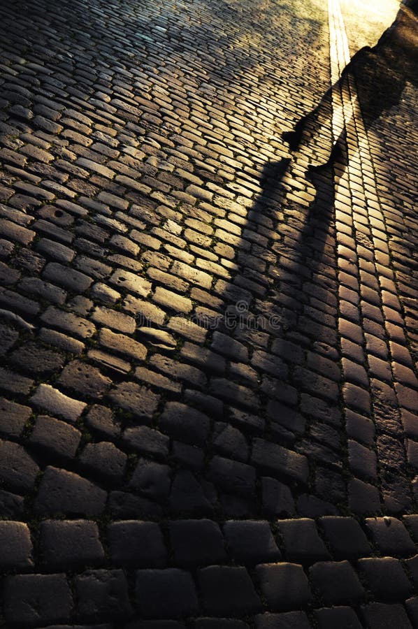 Walking on a cobbled street at night. Walking on a cobbled street at night