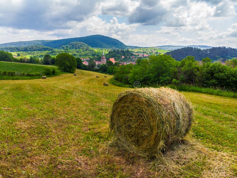 Straw bales on the field near Saschiz fortified church in Saschiz villages, Sibiu, Transylvania, Romania. Agriculture landscape, g royalty free stock photography Straw bales on the field near Saschiz fortified church in Saschiz villages, Sibiu, Transylvania, Romania. Agriculture landscape, g royalty free stock photography