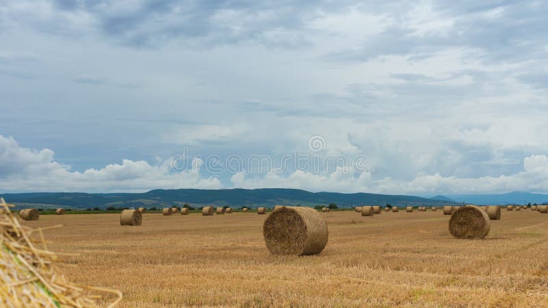 Straw bales under cloudy skies - time lapse