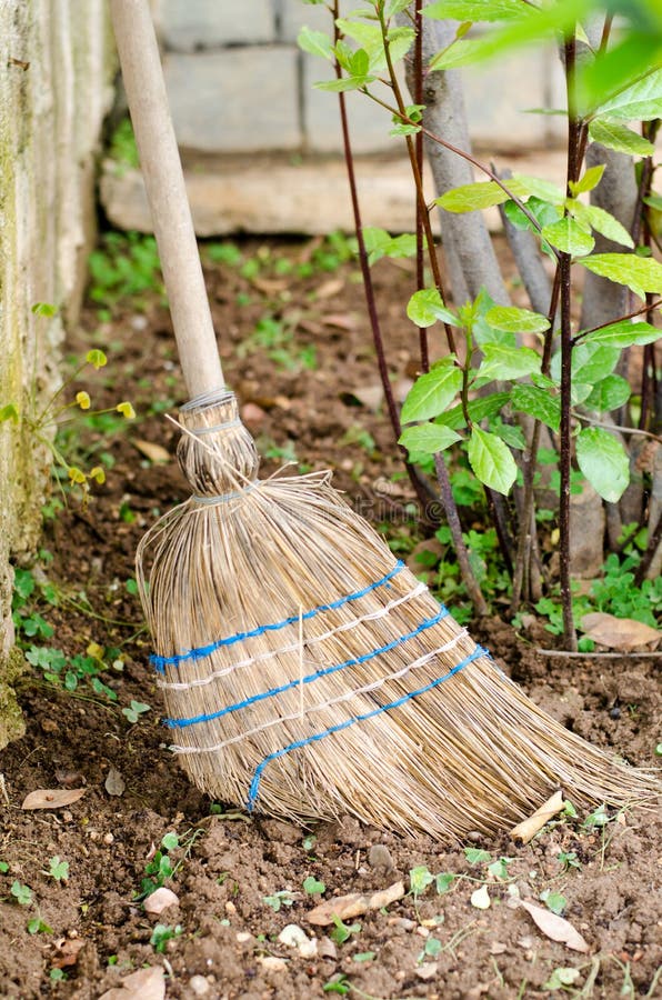 Straw broom ta the garden stock photo. Image of design 79063294