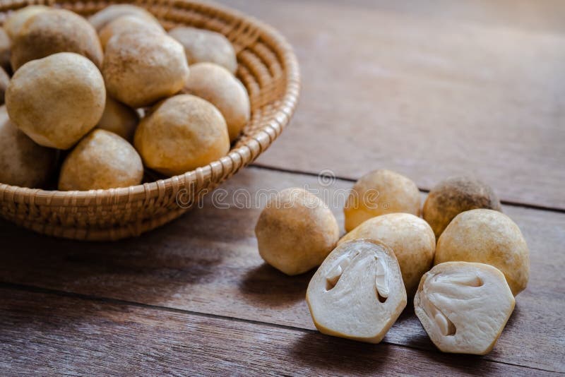 Straw mushroom on wooden table stock photo