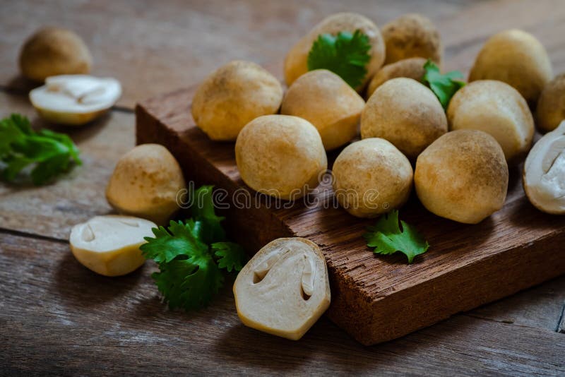Straw mushroom on wooden table royalty free stock photography
