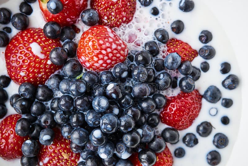 Strawberries, Blueberries and Milk in a White Bowl Stock Photo Image