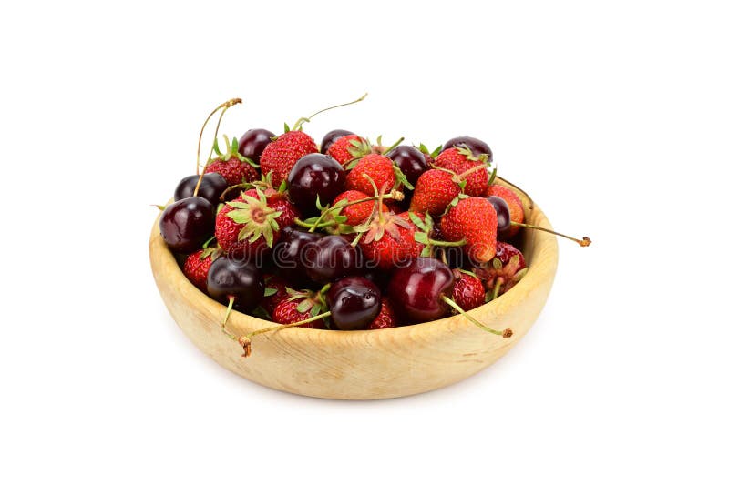 Strawberries and cherries laid out with a slide in a wooden plate