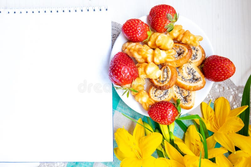 Strawberries, cookies hearts, yellow flowers daffodils for Valentine mother woman Easter day
