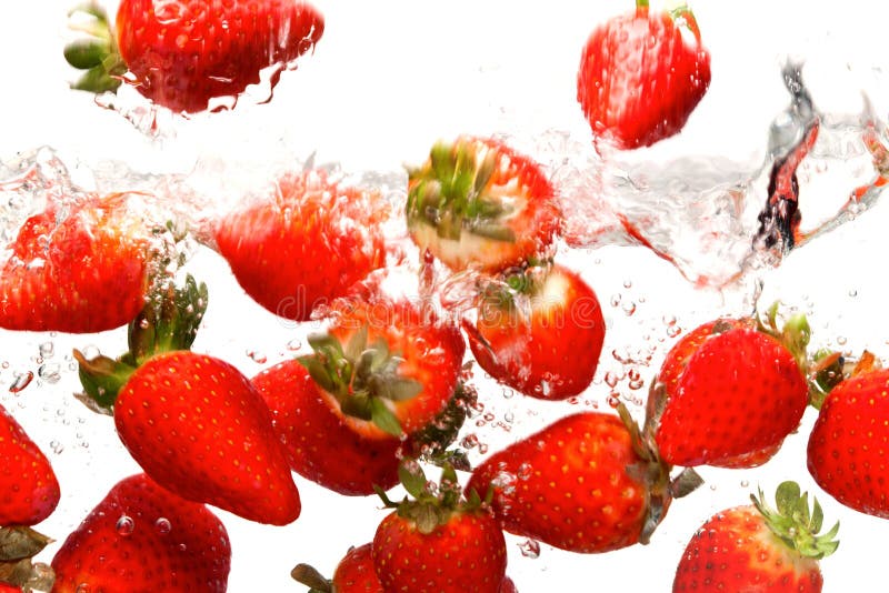 Strawberries falling in water