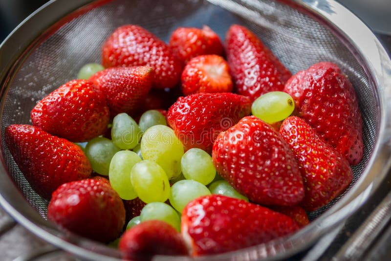 Strawberries and grapes stock image. Image of eating 90916929