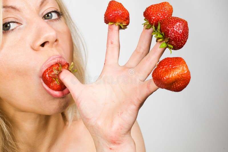 Strawberries picked on fingertips