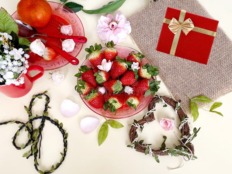 Strawberries and slices gift box,heart white background, flowers red cup branch  shape of romantic  still life