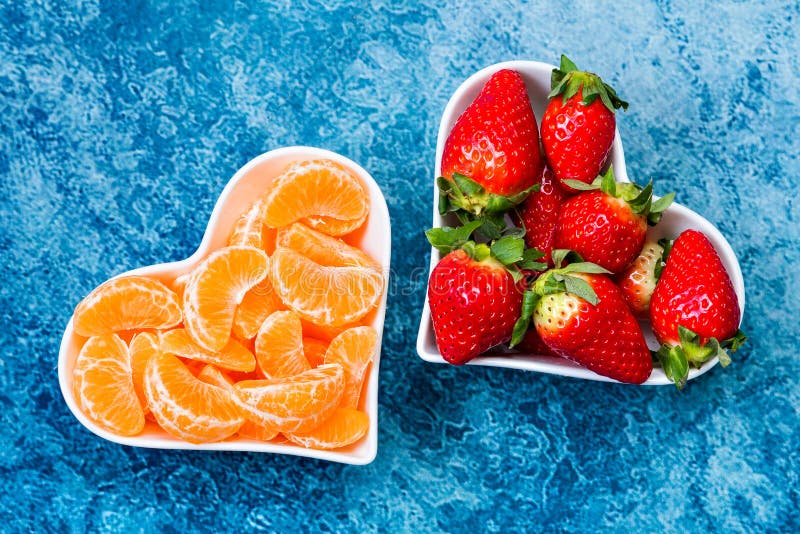 Strawberries and tangerine slices in plates royalty free stock image Strawberries and tangerine slices in plates royalty free stock image