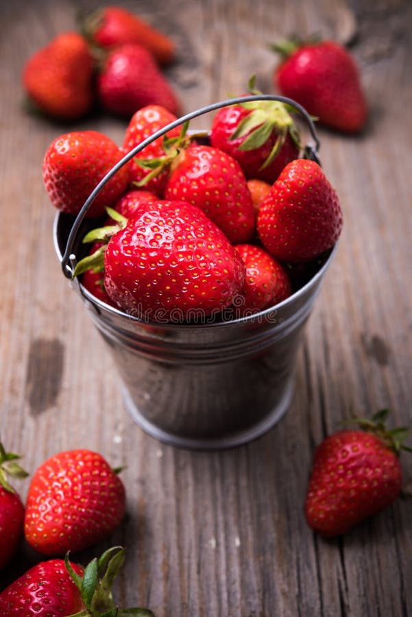 Strawberries in tiny metal bucket