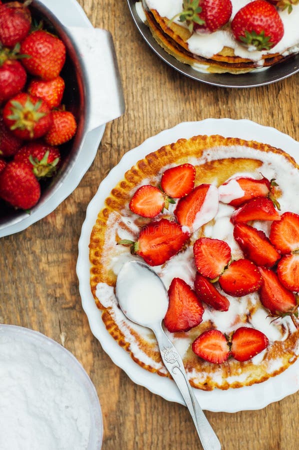 Strawberries and Whipped Cream for Dessert. Pancakes with Stra Stock