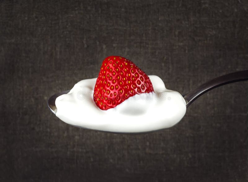 Juicy strawberries at home cream on a silver spoon. Juicy strawberries at home cream on a silver spoon