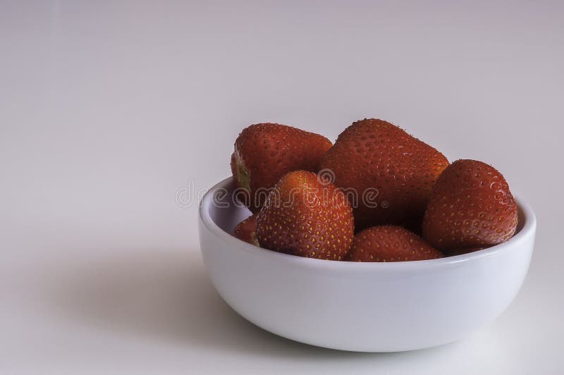 Strawberry in bowl stock photos