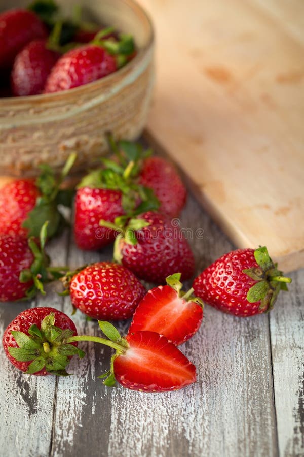 Strawberry In a bowl On a Wooden Background royalty free stock image