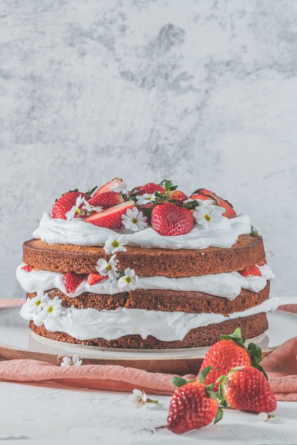 Strawberry cake, strawberry sponge cake with fresh strawberries and sour cream on a white background