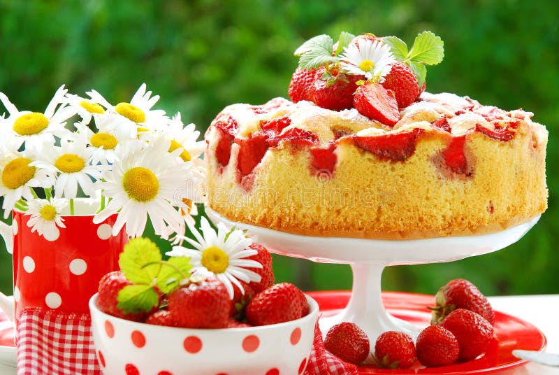 Strawberry sponge cake with fresh fruits decoration on table in the garden. Strawberry sponge cake with fresh fruits decoration on table in the garden