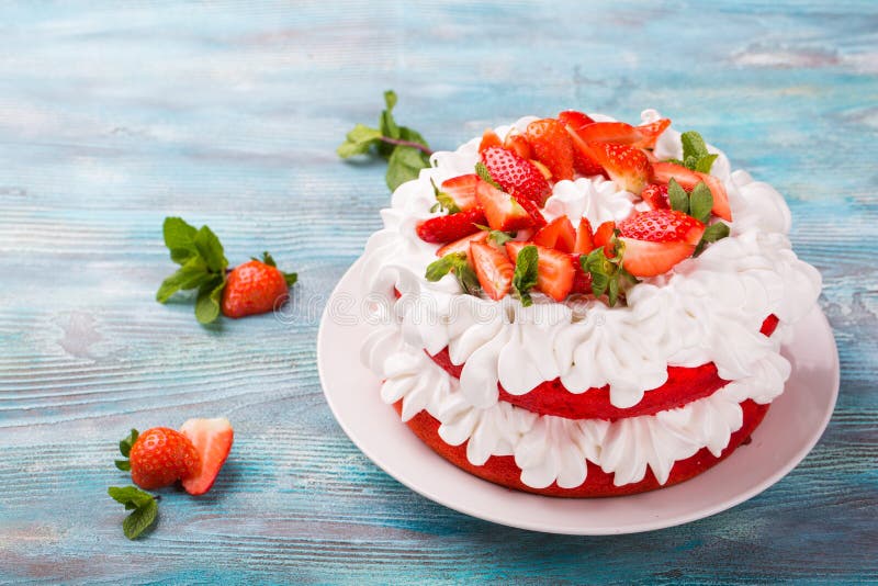 Strawberry and cream sponge cake. Homemade summer dessert on blue wooden table royalty free stock photo Strawberry and cream sponge cake. Homemade summer dessert on blue wooden table royalty free stock photo