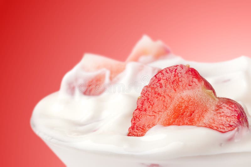 Strawberry into glass with yogurt