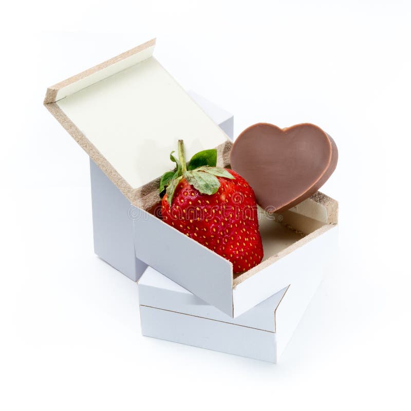 Strawberry And Heart-shaped Chocolate In A Box On White 