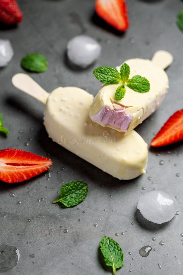 Strawberry Ice Cream on Stick Covered with White Chocolate Stock Photo