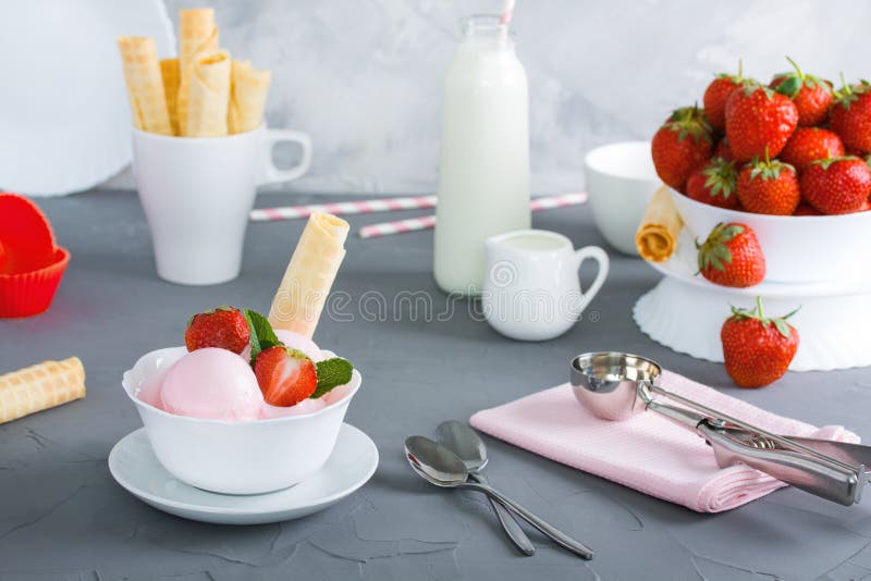 Strawberry ice cream in white plate with berrys wafer tubule