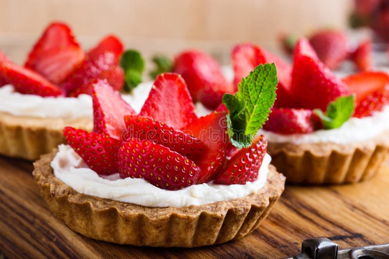 Strawberry shortcake pies on rustic wooden table