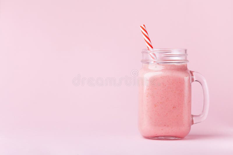 Strawberry smoothie or milkshake in mason jar on pink pastel background. Healthy food for breakfast and snack. royalty free stock photo Strawberry smoothie or milkshake in mason jar on pink pastel background. Healthy food for breakfast and snack. royalty free stock photo