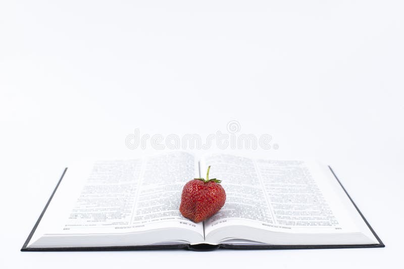 Strawberry. Strawberries on a Book. Concept. Holy Bible. on a White