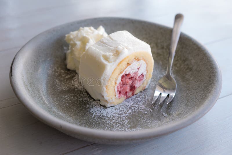 Strawberry Swiss Cream Roll Cake in Dish with Whipped Cream. Stock